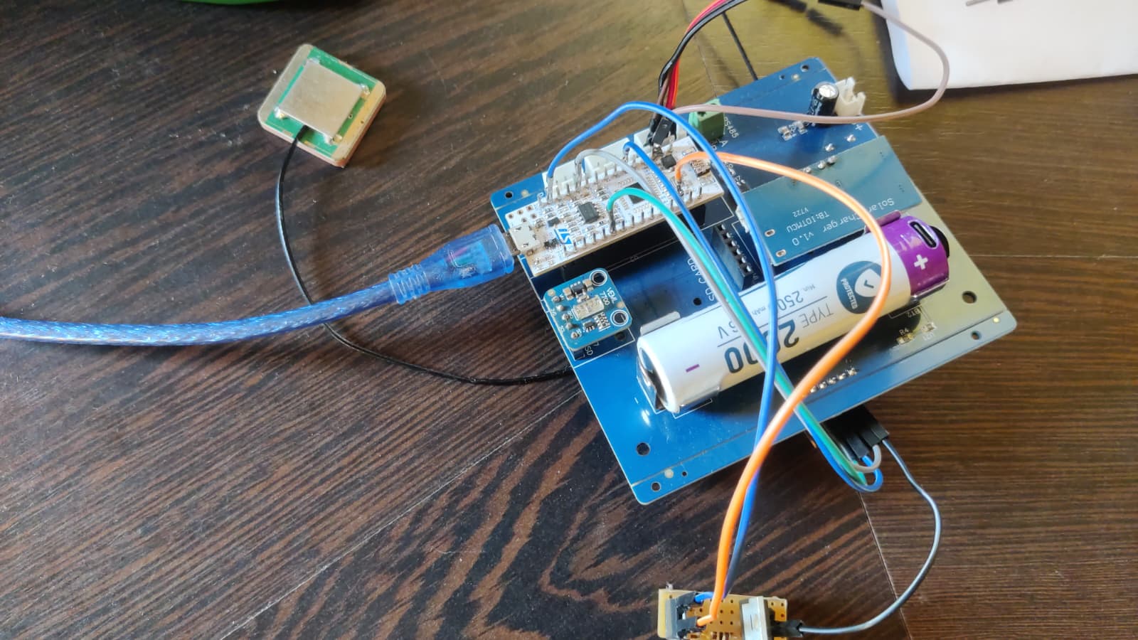 The working prototype assembled on a development board, with temporary wiring and a battery